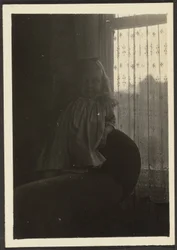 Little Girl Leaning on Chair Back