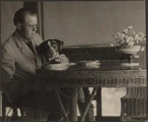 Man and Dog Seated at Table