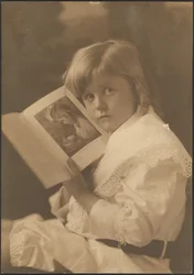 [Portrait of Child Holding Book Open to Like Illustration]
