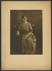 Portrait of a Seated Woman in Dress with Ribbon Accents