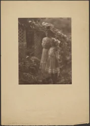 Two young girls standing in a garden