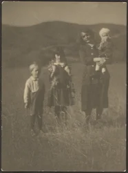 Woman and Three Children in Field