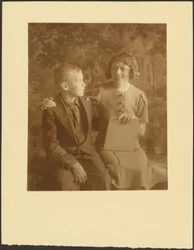 Woman and Young Man Seated Before Tapestry