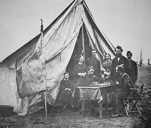 Colonel James P. McMahon with family and friends playing chess at the 164th New York Infantry Regiment headquarters