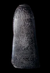 Kudurru in black limestone by King Marduk-sapik-zari (1082-1070 BC). Stele used as a support for donations of land made by the Kassite rulers of Babylon to family members or high dignitaries. The inscription is in cuneiform