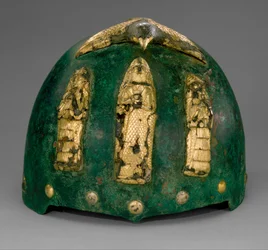 Helmet with divine figures beneath a bird with outstretched wings, c.1500-1100 BC