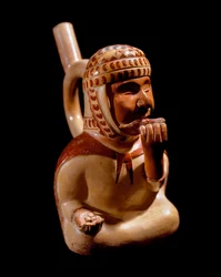 Precolombian art, Mochica civilization: anthropomorphic vase representing a blind beggar playing a musical instrument (pan flute?). 200 BC-700 AD