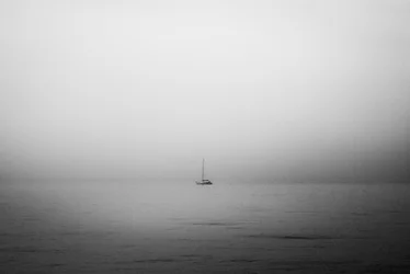 Lonely Sailboat In Fog