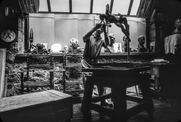 Sculptor Walker Hancock working in his art studio