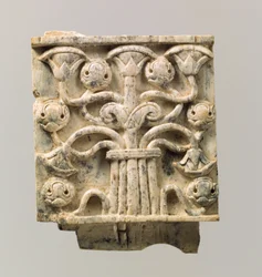 Furniture plaque carved in relief with stylized tree