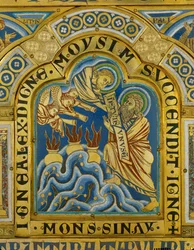 God gives Moses the Ten Commandments, while angels blow trumpets