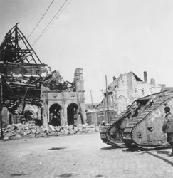 British tank in front of ruined buildings, Peronne, France, World War I, c1916-c1918