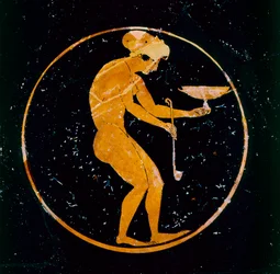 Athenian red-figure cup with a naked girl holding a cup and ladle inside, 520 BC