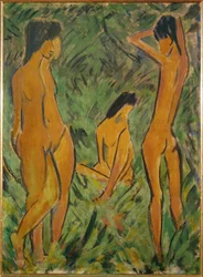 Boy in front of two girls, one standing, one seated