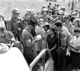 An American soldier attempts to communicate with local people, Orleans