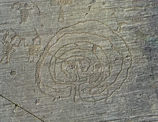 Prehistory, Camunni civilization, rock art: a grave rock of the representation of warriors weapons of shields and swords, and a maze. Period between the Neolithic and the Bronze Age. Capo di Ponte, Parco nazionale delle incisioni rupestri di Naquane, Valca
