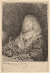 Man at a Desk Wearing a Cross and Chain