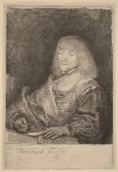 Man at a Desk Wearing a Cross and Chain