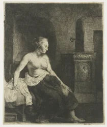 Woman sitting half dressed beside a stove