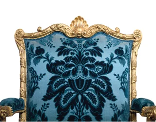 One of a pair of George III giltwood armchairs