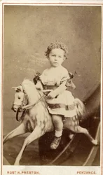 Young girl sitting on a rocking horse