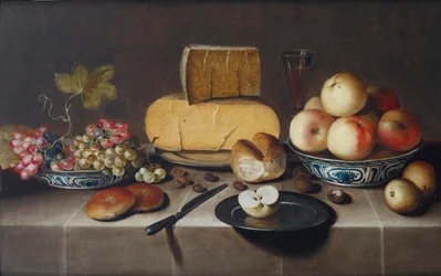 Cheese on a Silver Plate, Red and White Grapes and Apples in Porcelain Wanli Bowls, Bread Rolls, a Knife and a Sliced Apple on a Plate, All on a Draped Table
