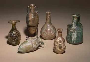 A group of delicate Roman blown and mould blown glass cosmetics flasks, 1st century AD