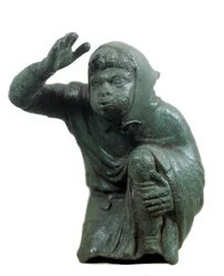 Roman art: bronze statuette of a Black slave kneeling and blowing. 2nd or 3rd century AD. Paris, Louvre Museum