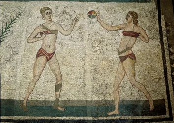 Roman art: young women playing ball. Young Romans engaged in physical exercises. They wear a loincloth around the kidneys and a strophium
