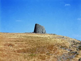 Nuragic culture (nuraghi) Sardinian: ruins of the nuragic city on the megalithic site of Macomer: one of the nuragic towers. Macomer, Sardinia Italy
