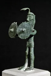 Statuette representing a demonic creature armed with a double shield in bronze. 8th-7th century BC. Museo Nazionale Archeologico, Cagliari, Sardinia, Italy