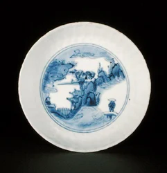 Blue and white kraak saucer dish painted with a figure in a landscape, Egret mark, Wanli or Tianqi