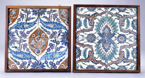 An Iznik tile with plum blossoms and tulips, made circa 1570, and a 17th century Iznik tile with red and blue split palmette