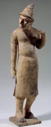 Chinese art: Sogdian, barbarian terracotta statuette with pointed hat carrying silk