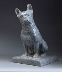 A grey marble figure of a pug