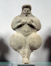 Terracotta statuette of woman holding her breasts, probable representation of Ishtar, goddess of fertility. From Susa. Iran. Elamite period. 14th-12th century BC. Louvre Museum