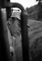Engineer of the Great Northern Railroad looks out from the window of the cab of an EMD E7 locomotive