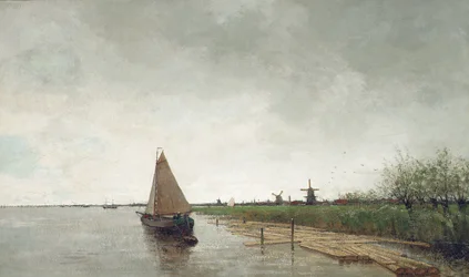 A river landscape with vessels, a city beyond