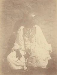 Portrait of a North African Woman Sitting Against a Wall