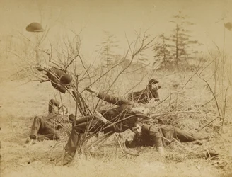[Four male students reclining al fresco]