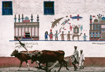 Painted mural on stucco wall of a farmhouse in Luxor commemorates the farmer