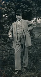 A gentleman wearing a suit and bowler hat