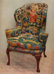 An Upholstered Armchair with Wings, Carved Walnut Frame and Original Silk Needlework Covering