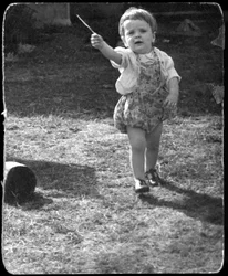 Andrew Nurnberg, son of photographer Walter with stick in garden