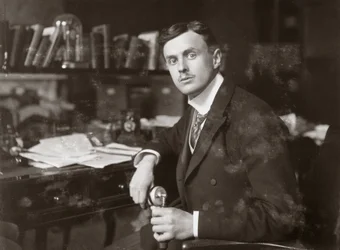 C S Rolls sitting at his desk