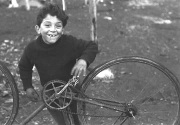Child fixing a bike, Borghetto Nomentano, Rome, Italy