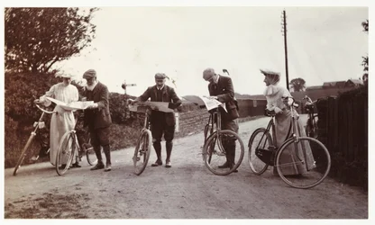 Cyclists looking at maps, c 1900