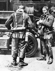 Firefighters donning smoke helmets, Farringdon Street rubber works, London