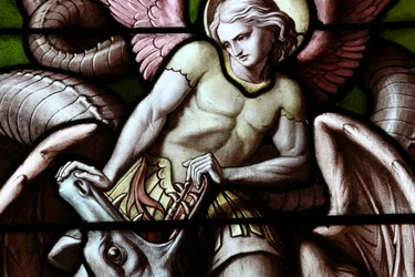 Basilica Notre-Dame of Geneva. Stained glass window. Angel fighting Satan as a dragon.
