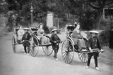 Japanese Ladies in Rickshaws Drawn by Coolies
